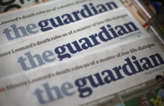 Copies of the Guardian newspaper are displayed at a news agent in London August 21, 2013. REUTERS/Suzanne Plunkett